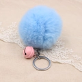 Detail of light blue faux fur pompom keychain with a pink bell and silver metal ring - 8cm Faux Rabbit Fur With Bell / Sky Blue