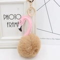 Close-up of pink flamingo plush keychain with brown fur ball and golden metal clasp - Khaki and Pink
