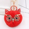 Detailed view of a red owl plush keychain with shiny sequins and golden metal clip - Gold Key Chain Style / Bright Red