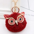 Close-up of red sequin owl plush keychain with fluffy faux fur and gold metal details - Gold Key Chain Style / Wine Red