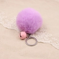 Detail of soft purple faux rabbit fur pom pom keychain with a pink metal bell accent - 8cm Faux Rabbit Fur With Bell / Taro Purple