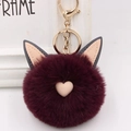 Détail d'un porte-clés en peluche violet foncé avec oreilles de chat et cœur rose - Style Chaîne De Clé Or / Rouge Pourpre