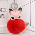Detail view of pink faux leather fox keychain with a fluffy red pompom and silver ring - Silver Keyring / Red