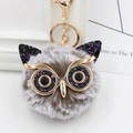 Close-up of owl keychain with grey faux fur, glitter details, and gold lobster clasp - Gold Key Chain Style / Two-tone Gray Black