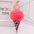 Close-up of pink leopard print ice cream keychain with plush pom pom and golden metal clasp - Gold Key Chain Style / Rose Red