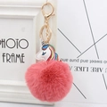Pink fluffy faux fur unicorn keychain with golden metal clasp and rainbow hair details - Dust Rose