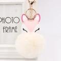 Detail of pink fox faux fur pompom keychain with gold ring and soft plush texture - Off White