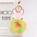 Detail of fox plush keychain featuring embroidered eyes and a colorful rainbow fur ball - Colorful Polka Dots