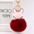 Detail of fox plush keychain with pink faux leather embroidery and dark red fluffy ball - Burgundy