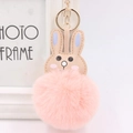 Detail of cute pink faux fur bunny keychain with golden metal ring and soft leather ears - Pink