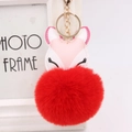 Detail of fox plush keychain with pink PU leather head and large red faux fur ball - Red
