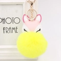 Detail of yellow plush fox keychain with pink ears and golden alloy hardware - Yellow