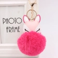 Detail of rose red faux fur pompom fox keychain with golden lobster clasp hardware - Rose Red