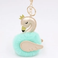 Detailed close-up of mint green swan plush charm with golden wings and a crown decoration - Mint Green-Champagne