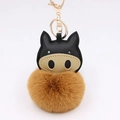 Detail of cartoon pig keychain with golden metal clasp and soft faux fur pompom - Coffee