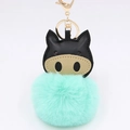 Close-up of mint green plush pig keychain with black leather ears and gold metal clasp - Mint Green