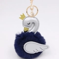 Detailed close-up of swan plush keychain with silver leather and blue pom-pom - Navy Blue-Silver