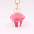 Close-up of pink pom pom cupcake keychain with gold metal lobster clasp and striped base - Deep Pink