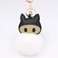 Detail of cartoon pig keychain with white faux fur pompom and golden metallic clasp - White