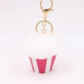 Detail of plush cupcake keychain with white faux fur cream and pink striped base - White