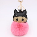 Macro detail of cute pink plush puff keychain with cartoon animal head and gold metal clasp - Deep Pink