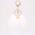 Detail of white faux rabbit fur pompom keychain with golden metal clasp and gemstone bead - White