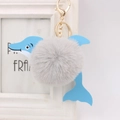 Detailed view of dolphin plush keychain with grey faux fur ball and gold lobster clasp - Light Gray