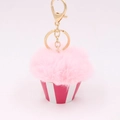 Close-up of pink pom pom cupcake keychain with red striped base and golden metal clasp - Light Pink