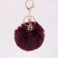 Detail of burgundy faux rabbit fur keychain with gold lobster clasp and diamond pendant - Purplish Red