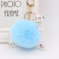 Detail of blue plush fur ball and deer leather keychain with bohemian floral patterns - Light Blue
