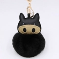 Cartoon pig plush keychain with black faux leather and golden snout on white background - Black