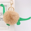 Cute green dinosaur plush pom-pom keychain with soft faux fur and gold metal hardware - Dinosaur Style / Khaki