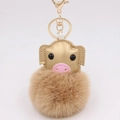 Detail view of cute pig plush keychain with golden faux leather and brown pom pom - Gold 8-shaped Clasp / Khaki Gold