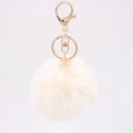 Detail of a beige faux fur keychain with gold-tone hardware and geometric crystal pendant - Off-white