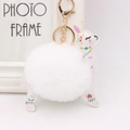 Detail of white plush alpaca keychain with floral faux leather and gold lobster clasp - White