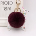 Detailed view of alpaca keychain with wine red fur ball and golden clasp for bags - Purplish Red