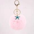 Close-up of pink pompom keychain with teal starfish charm and gold metal lobster clasp - Light Pink