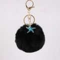Detail of black faux fur pompom keychain with teal starfish charm and gold lobster clasp - Black