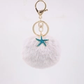 Detailed macro view of the fluffy lavender pompom and blue starfish gold keychain charm - Light Gray
