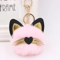 Detail view of pink plush cat keychain with golden whiskers and metal heart clip - Light Pink