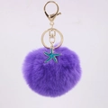 Detailed view of purple pompom keychain with golden metal ring and blue starfish charm - Deep purple