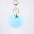 Detailed close-up of light blue faux fur pompom keychain with a teal starfish pendant - Light Blue