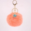 Detail of coral orange pompom keychain with a turquoise starfish charm and gold ring - Orange Red