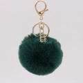 Close-up of fluffy dark green faux fur keychain with gold lobster clasp and geometric charm - Dark Green