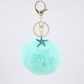 Mint green faux fur pompom keychain with a blue starfish pendant and gold metal hardware - Mint Green