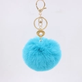 Close-up of fluffy blue faux fur keychain with gold shell pearl pendant and lobster clasp - Lake Blue
