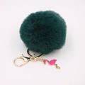 Detailed close-up of dark green faux fur pompom keychain with golden flamingo charm - Dark Green
