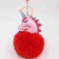 Detailed macro view of a pink unicorn plush head and fluffy red pompom keychain with golden clip - Unicorn Keychain / Red