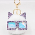 Détail d'un porte-clés chat en peluche blanc avec oreilles pailletées et lunettes hologramme - Blanc