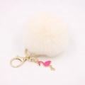 Detail of a fluffy cream faux fur pompom keychain with a pink flamingo enamel charm - Off-white